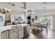 Open concept living space with a kitchen, dining area, and comfortable seating by a fireplace at 4205 E 106Th Pl, Thornton, CO 80233