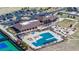 An aerial view shows community amenities including the clubhouse, swimming pool, tennis courts and parking at 8463 S Quemoy Ct, Aurora, CO 80016