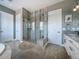 Contemporary bathroom with a glass shower, elegant tub, and stylish vanity, complete with neutral colors and finishes at 8463 S Quemoy Ct, Aurora, CO 80016