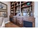Custom built in shelving features drawers and cabinets for storage and display, adding elegance to the living space at 8463 S Quemoy Ct, Aurora, CO 80016