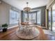 Charming dining nook with bay window, shutter blinds, stylish chandelier, and sliding doors leading to an outdoor area at 8463 S Quemoy Ct, Aurora, CO 80016