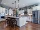 Gourmet kitchen with an island, stainless steel appliances, and ample cabinet space at 8463 S Quemoy Ct, Aurora, CO 80016