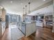 Bright, open-concept kitchen features a large island, pendant lighting, and seamless flow to the living and dining areas at 8463 S Quemoy Ct, Aurora, CO 80016