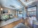 Open-concept living area with hardwood floors, stylish seating, and seamless flow into adjacent spaces at 8463 S Quemoy Ct, Aurora, CO 80016