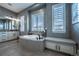 Main bathroom features a soaking tub with natural light and ample cabinet storage space at 8463 S Quemoy Ct, Aurora, CO 80016
