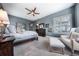 Serene main bedroom with a ceiling fan, shuttered windows, and a neutral color palette for a relaxing retreat at 8463 S Quemoy Ct, Aurora, CO 80016