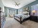 Serene primary bedroom with plush carpeting, bay window, and a luxurious king-sized bed at 8463 S Quemoy Ct, Aurora, CO 80016
