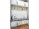 Mudroom featuring a built-in bench with storage, coat hooks, and decorative pillows at 8463 S Quemoy Ct, Aurora, CO 80016