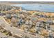 Aerial view of a neighborhood near a lake, showcasing the community setting and location at 853 Mockingbird St, Brighton, CO 80601