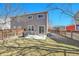 Spacious backyard with a patio area, lawn, and wooden fence at 853 Mockingbird St, Brighton, CO 80601
