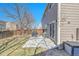 Spacious backyard with a concrete patio, grill, and a wood fence for privacy at 853 Mockingbird St, Brighton, CO 80601