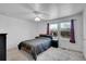 Bright bedroom with a large window, ceiling fan, and neutral carpet at 853 Mockingbird St, Brighton, CO 80601