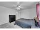 Bedroom with a ceiling fan and a black dresser at 853 Mockingbird St, Brighton, CO 80601
