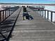 Scenic wooden dock with benches overlooking the water and distant mountain views, perfect for community enjoyment at 853 Mockingbird St, Brighton, CO 80601