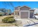 Charming two-story home featuring a spacious two car garage with a well-maintained lawn and inviting front entrance at 853 Mockingbird St, Brighton, CO 80601