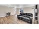 Open-concept living area featuring modern furniture, hardwood floors, and ample natural light for a welcoming atmosphere at 853 Mockingbird St, Brighton, CO 80601