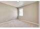 Well-lit bedroom with carpet flooring and window at 18359 Field Mint Pt, Parker, CO 80134
