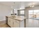 Open kitchen with island, stainless steel appliances, and views to living room at 18359 Field Mint Pt, Parker, CO 80134