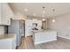 Modern kitchen with white cabinets, granite island, and stainless steel appliances at 18359 Field Mint Pt, Parker, CO 80134