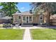 Backyard featuring a custom shed, lush lawn, brick patio, and outdoor seating area at 3820 S Grant St, Englewood, CO 80113