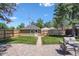 Private backyard featuring a lush lawn, custom shed, and lovely brick patio at 3820 S Grant St, Englewood, CO 80113