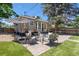 Inviting backyard patio features stylish furniture and a large umbrella, perfect for outdoor relaxation and entertaining at 3820 S Grant St, Englewood, CO 80113