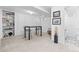 Basement with tile floor section featuring a table with seating, built-in shelves, and painted white walls at 3820 S Grant St, Englewood, CO 80113