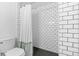 Modern bathroom features subway tile shower with black hardware and sleek fixtures at 3820 S Grant St, Englewood, CO 80113