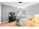 Cozy bedroom with hardwood floors, dresser, and natural light from windows at 3820 S Grant St, Englewood, CO 80113