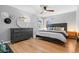 Bright bedroom with hardwood floors, large dresser, and natural light from two windows at 3820 S Grant St, Englewood, CO 80113