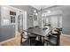 Open dining room featuring modern lighting, wood floors, and view of kitchen and living room at 3820 S Grant St, Englewood, CO 80113