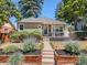 Charming home with a well-kept front yard, covered porch and beautiful landscaping at 3820 S Grant St, Englewood, CO 80113