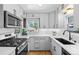 Bright kitchen featuring stainless steel appliances, white cabinets, and subway tile backsplash at 3820 S Grant St, Englewood, CO 80113