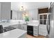 Kitchen with stainless steel appliances, white cabinets, and eat-in dining area at 3820 S Grant St, Englewood, CO 80113
