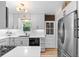 Kitchen featuring stainless steel refrigerator, white cabinets, and hardwood floors at 3820 S Grant St, Englewood, CO 80113