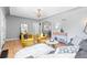 Well-lit living room with hardwood floors, stylish seating, and an open concept design at 3820 S Grant St, Englewood, CO 80113