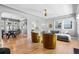 Spacious living room with hardwood floors, modern decor, and an open layout to the dining area at 3820 S Grant St, Englewood, CO 80113