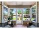 Cozy sunroom with tile floors, surrounded by windows, and backyard views at 3820 S Grant St, Englewood, CO 80113