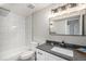 Modern bathroom featuring stylish vanity, dark fixtures, bright lighting, and tiled shower/tub combination at 909 Reynolds Farm Ln # C2, Longmont, CO 80503