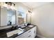 Dual sink bathroom with sleek vanities, dark granite counters, and modern lighting fixtures, creating a spa-like retreat at 909 Reynolds Farm Ln # C2, Longmont, CO 80503