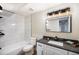 Elegant bathroom features tiled shower, stylish vanity with dark fixtures, and well-lit mirror, maximizing comfort at 909 Reynolds Farm Ln # C2, Longmont, CO 80503