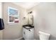Well-lit bathroom showcasing a sleek vanity, a framed window, and modern fixtures, offering comfort and style at 909 Reynolds Farm Ln # C2, Longmont, CO 80503