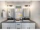 Modern bathroom with dual vanity, granite countertop, and updated lighting at 909 Reynolds Farm Ln # C2, Longmont, CO 80503