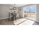 Bright dining area with slider to outdoor deck and modern lighting at 909 Reynolds Farm Ln # C2, Longmont, CO 80503