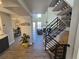 Inviting entryway with open staircase, modern decor, and stylish flooring at 909 Reynolds Farm Ln # C2, Longmont, CO 80503