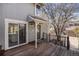The front of the home boasts a wooden deck, a front door, and sliding glass doors to the kitchen at 909 Reynolds Farm Ln # C2, Longmont, CO 80503