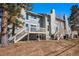 View of the back of the home with two decks and stairs that lead to the backyard at 909 Reynolds Farm Ln # C2, Longmont, CO 80503