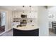 Lovely remodeled kitchen features white cabinetry, stainless appliances, quartz counters, and stylish backsplash at 909 Reynolds Farm Ln # C2, Longmont, CO 80503