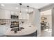 Lovely remodeled kitchen features white cabinetry, stainless appliances, quartz counters, and stylish backsplash at 909 Reynolds Farm Ln # C2, Longmont, CO 80503