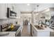 Bright kitchen boasts white cabinets, quartz counters, stainless appliances, and stylish backsplash at 909 Reynolds Farm Ln # C2, Longmont, CO 80503